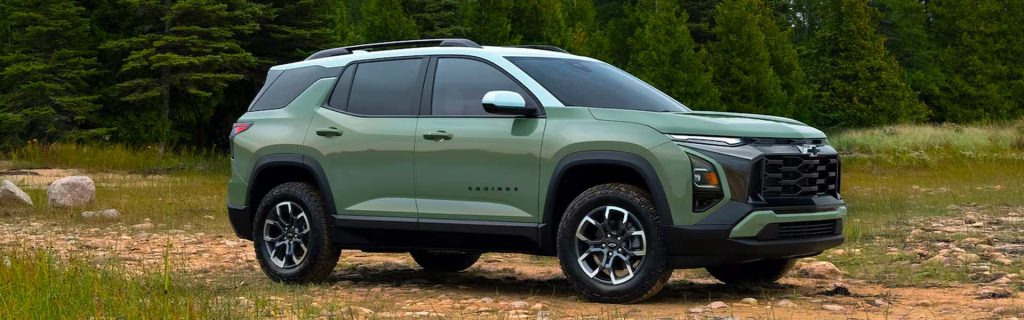 Green Chevrolet Equinox SUV parked outdoors with four people walking nearby.